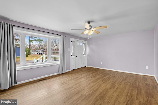 unfurnished room with ceiling fan and light hardwood / wood-style floors