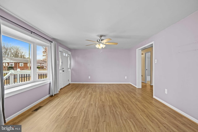 empty room with light hardwood / wood-style floors and ceiling fan