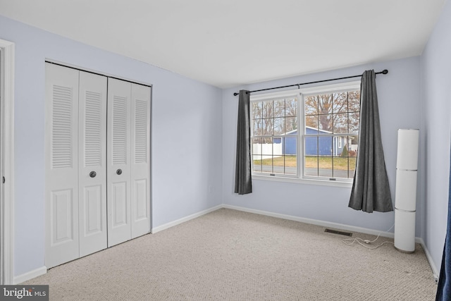 unfurnished bedroom featuring a closet and carpet flooring