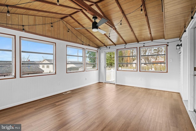 unfurnished sunroom with lofted ceiling with beams, wooden ceiling, and ceiling fan