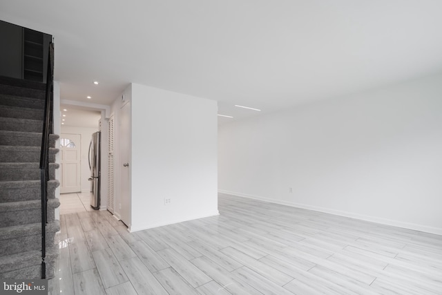 empty room with light hardwood / wood-style flooring