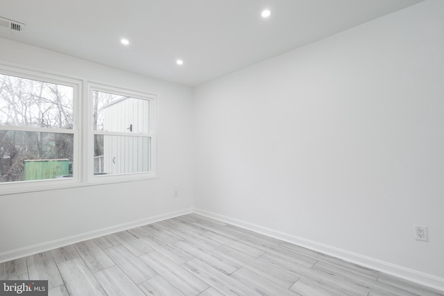 empty room with light hardwood / wood-style flooring