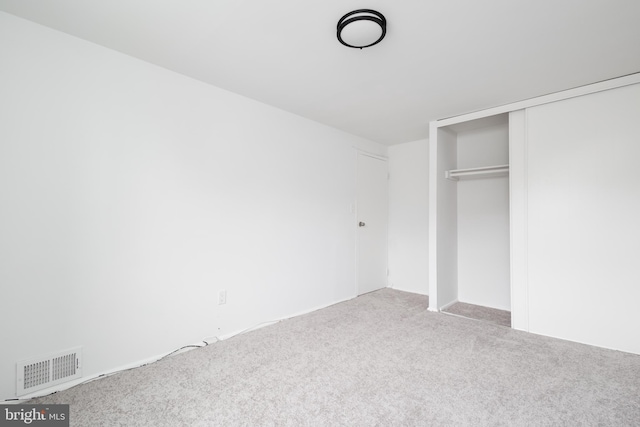 unfurnished bedroom with carpet flooring and a closet