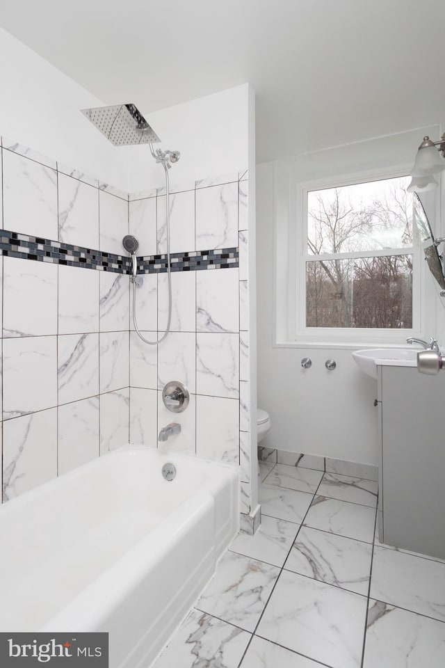 full bathroom featuring vanity, tiled shower / bath combo, and toilet