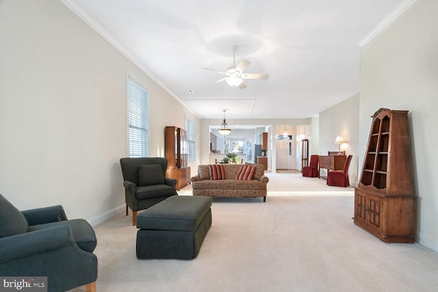 living room featuring ceiling fan, crown molding, and light carpet