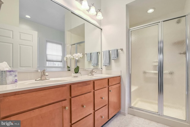 bathroom with tile patterned flooring, vanity, and a shower with door