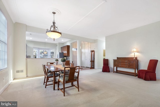 dining room featuring light carpet