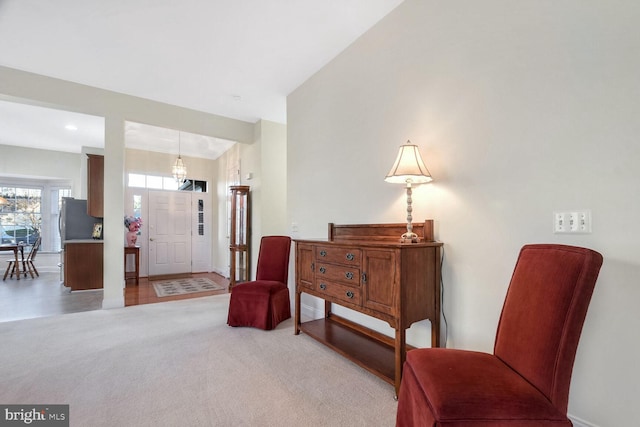 living area with light carpet and vaulted ceiling