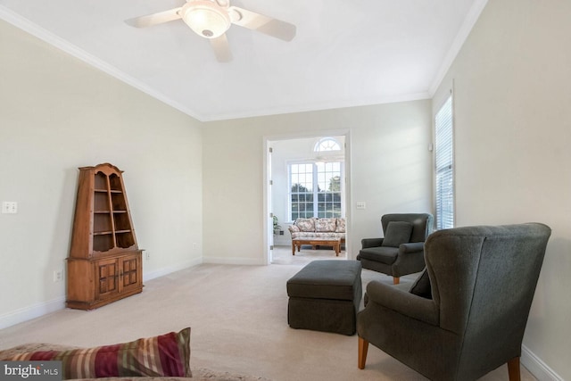 carpeted living room with ceiling fan and crown molding