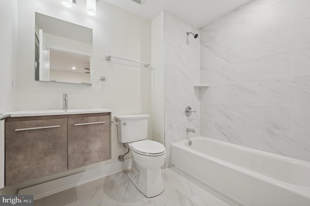 full bathroom with vanity, tiled shower / bath combo, and toilet