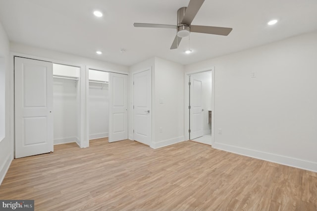 unfurnished bedroom with multiple closets, ceiling fan, and light hardwood / wood-style floors