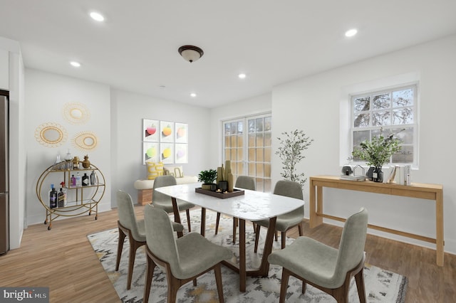 dining room with light hardwood / wood-style floors and a wealth of natural light