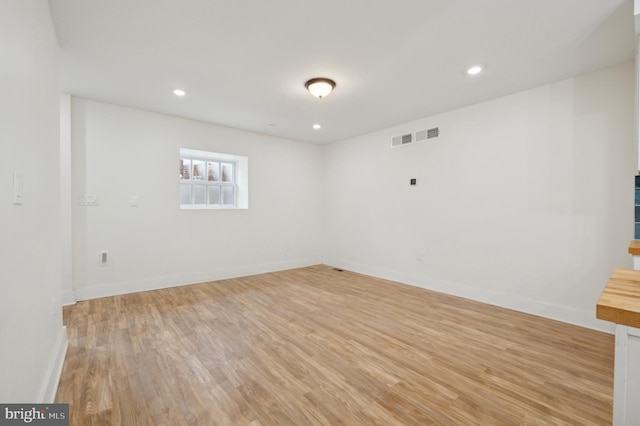 empty room with light hardwood / wood-style flooring