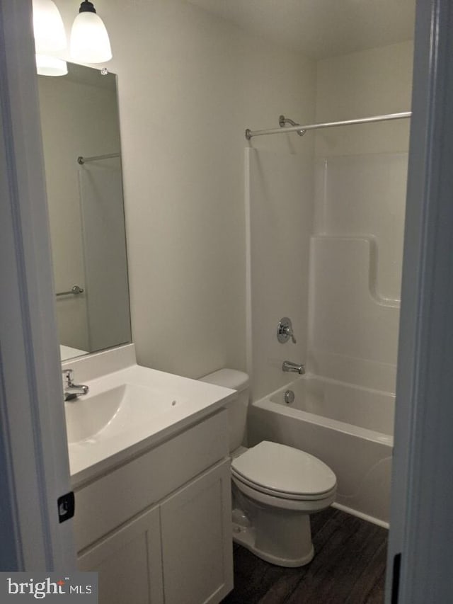 full bathroom featuring shower / bath combination, vanity, toilet, and wood-type flooring