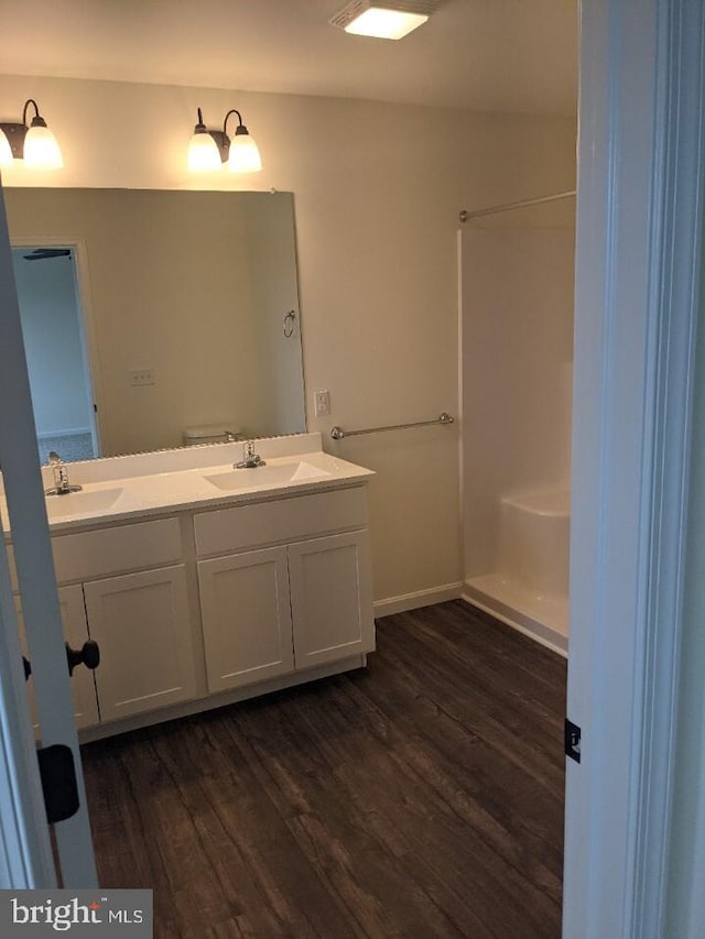 bathroom featuring hardwood / wood-style floors, vanity, and toilet