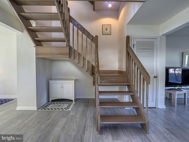 stairway with hardwood / wood-style flooring