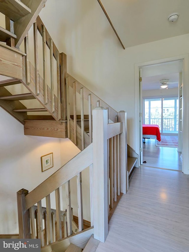 staircase featuring hardwood / wood-style floors and billiards