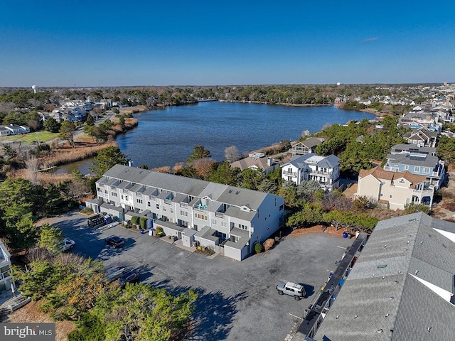 drone / aerial view with a water view and a residential view