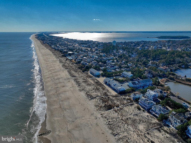 birds eye view of property featuring a water view and a beach view