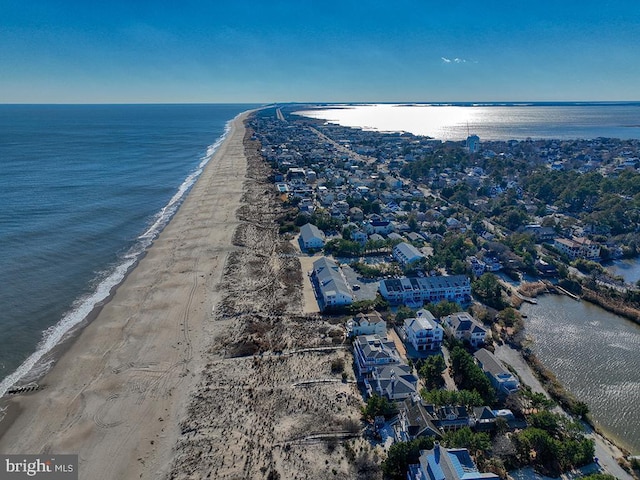 bird's eye view featuring a water view and a beach view