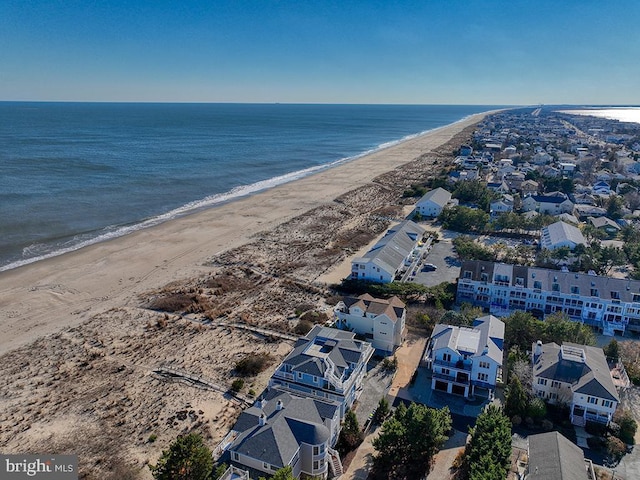 birds eye view of property with a view of the beach and a water view