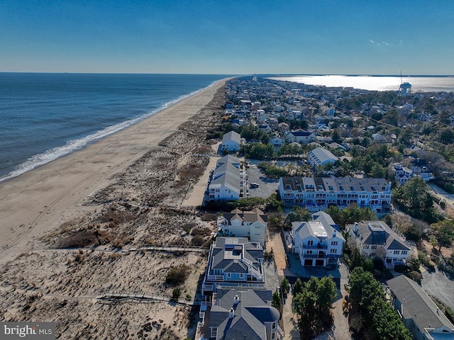 drone / aerial view featuring a beach view and a water view