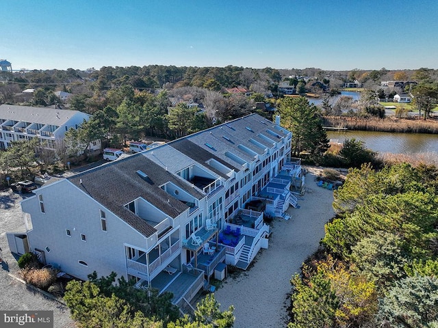 drone / aerial view featuring a residential view and a water view