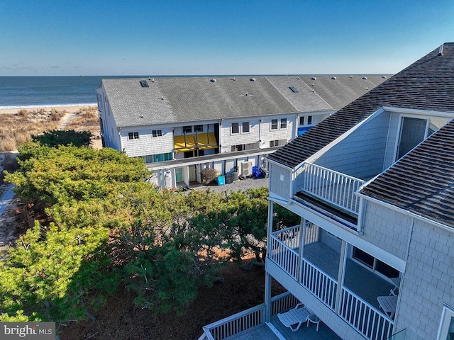 drone / aerial view featuring a water view and a beach view