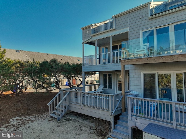 back of house featuring a deck and stairway