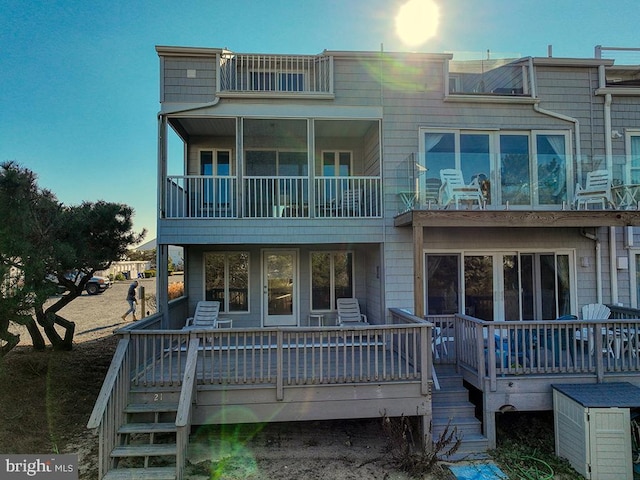 back of property with stairs and a wooden deck