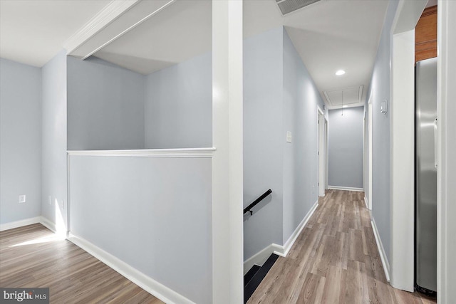 corridor with light hardwood / wood-style flooring