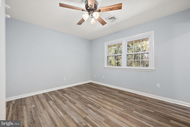 spare room with hardwood / wood-style floors and ceiling fan