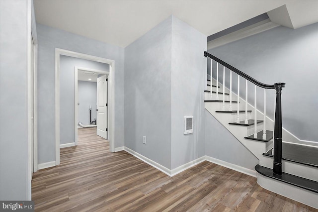 stairway with wood-type flooring