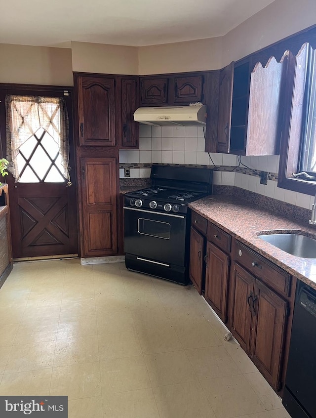 kitchen with black appliances, backsplash, dark brown cabinets, and sink