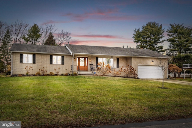 single story home with a lawn and a garage