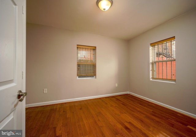 spare room with hardwood / wood-style flooring