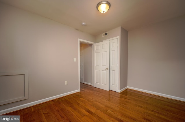 empty room with hardwood / wood-style floors