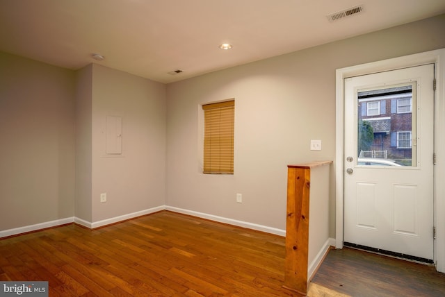 foyer featuring dark hardwood / wood-style flooring and electric panel