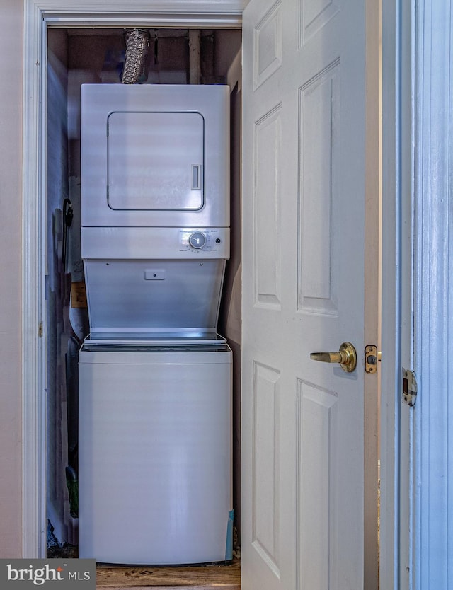 laundry area with stacked washer / dryer