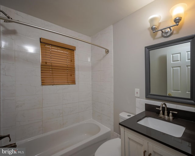 full bathroom with vanity, toilet, and tiled shower / bath