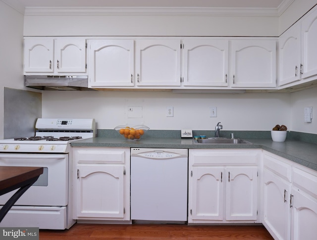 kitchen with white appliances, sink, and white cabinets