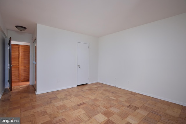 unfurnished bedroom with light parquet flooring