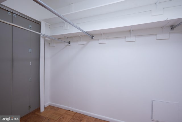 spacious closet with parquet flooring