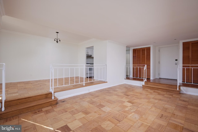 empty room with light parquet floors and crown molding