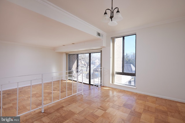 unfurnished room with crown molding, an inviting chandelier, and light parquet floors