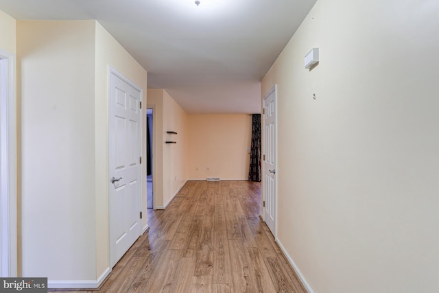 hallway with light hardwood / wood-style flooring