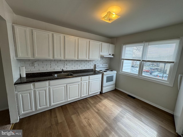 kitchen with decorative backsplash, white electric range oven, sink, white cabinets, and light hardwood / wood-style floors