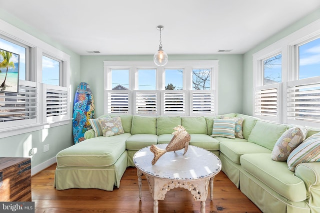 living room with a healthy amount of sunlight and hardwood / wood-style floors