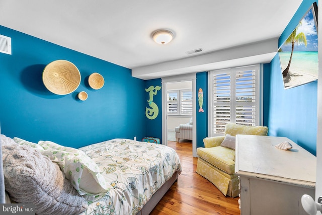 bedroom with wood-type flooring