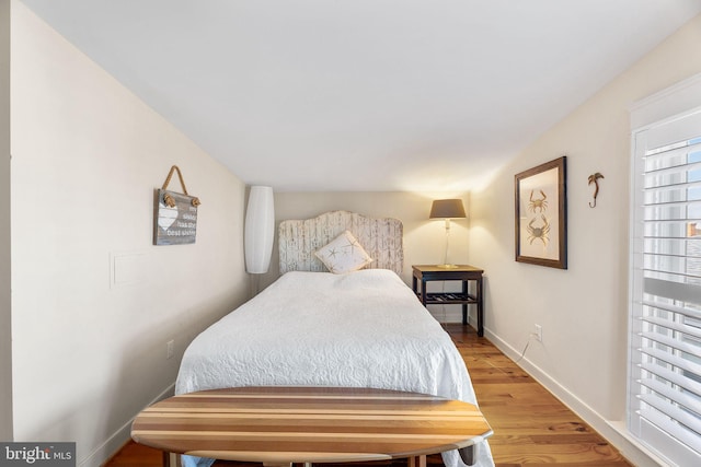 bedroom with hardwood / wood-style flooring